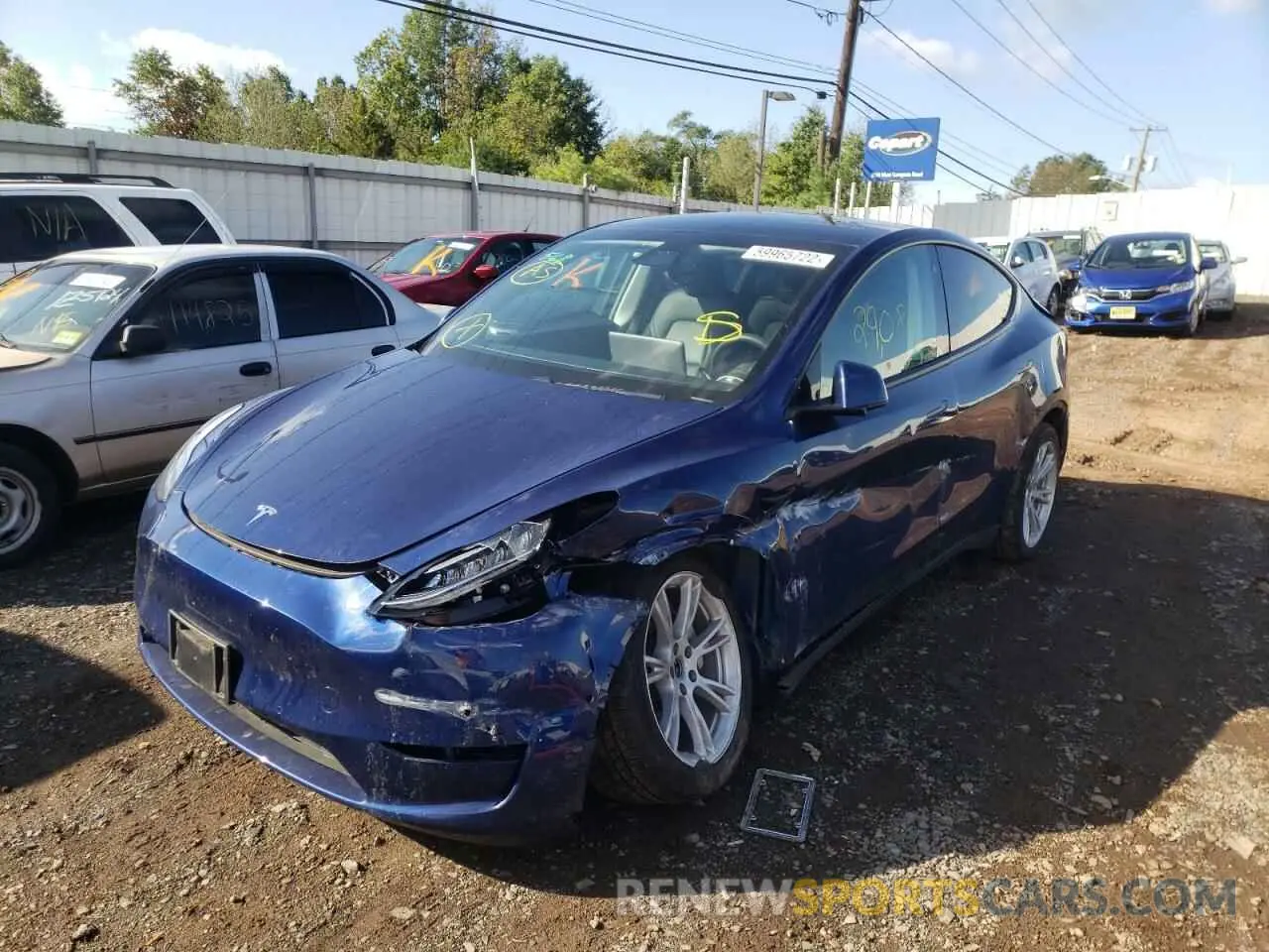 2 fotografías del automóvil dañado 5YJYGDEE3MF063711 TESLA MODEL Y 2021